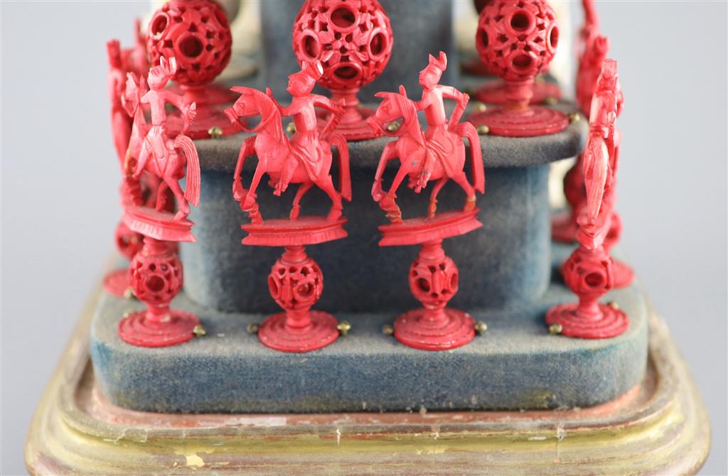 A set of 19th century Cantonese carved and red stained ivory chess pieces under dome, white king 20cm high